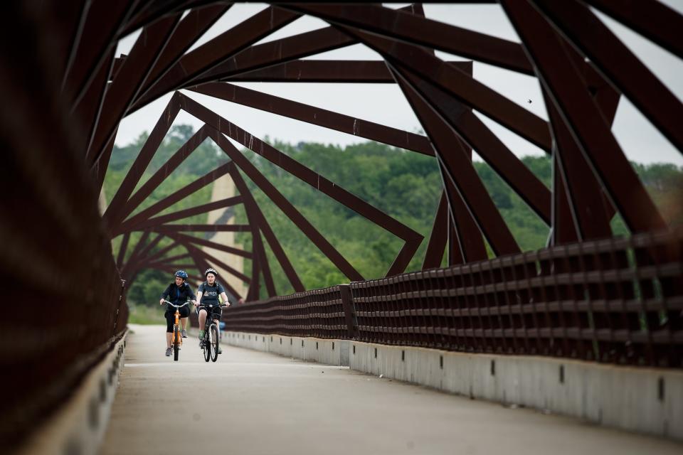 Cyclists ride across the High Trestle Trail Bridge in Madrid.
