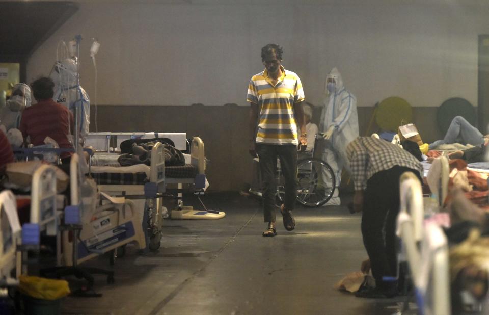 NEW DELHI, INDIA - APRIL 29: A men corona virus Covid-19 patient walk and rest an isolation ward at the temporary Covid Care facility center attached to LNJP Hospital, at Shehnai Banquet on April 29, 2021 in New Delhi, India. As Covid-19 cases continued to surge in Delhi with over 97,977 active cases people are struggling to get hospital beds, ventilators, oxygen cylinders, injections and medicines with the health infrastructure in the state almost stretched to its limit.  ( Photo by Sonu Mehta/Hindustan Times via Getty Images)