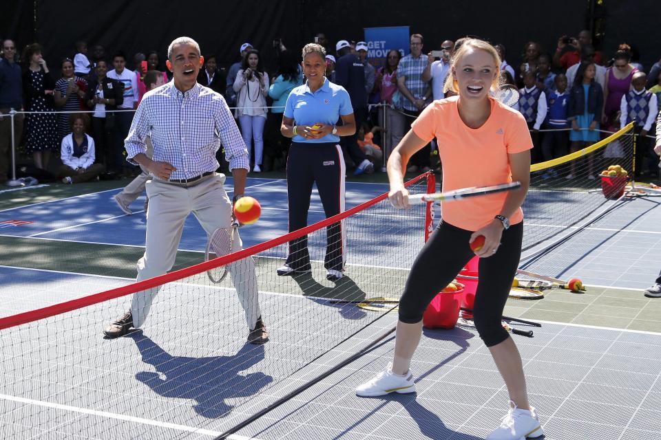 U.S. President Barack Obama plays tennis with tennis player Caroline Wozniacki, one of the activities at the annual Easter Egg Roll at the White House in Washington April 6, 2015. REUTERS/Jonathan Ernst