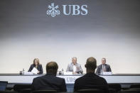 Group Chief Executive Officer of Swiss Bank UBS Sergio P. Ermotti, center, speaks next to Marsha Askins, left, and Todd Tuckner, right, during the presentation of the second quarter 2023 and first results since the Credit Suisse merger, in Zurich, Switzerland, Thursday, Aug. 31, 2023. Swiss banking giant UBS announced plans to save $10 billion in costs, including through 3,000 staff reductions in Switzerland in the coming years, as it moves ahead with “full integration” of longtime rival Credit Suisse’s domestic operations following a takeover. (Ennio Leanza/Keystone via AP)