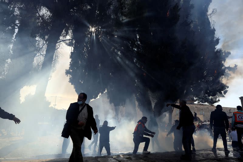 Palestinians put out a fire following a clash with Israeli security forces at the compound that houses Al-Aqsa Mosque, known to Muslims as Noble Sanctuary and to Jews as Temple Mount, in Jerusalem's Old City