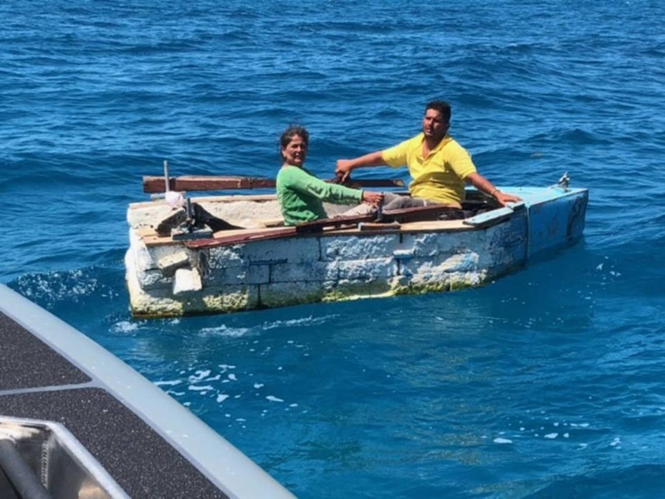 A man and woman from Cuba sit in a makeshift Styrofoam raft offshore of Key Largo Tuesday, May 5, 2021.