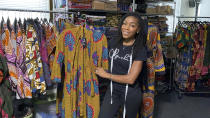 Iguehi James, an Oakland fashion entrepreneur, shows a kimono duster she designed for her apparel company Love Iguehi, Tuesday, Sept. 15, 2020, in Oaklnad, Calif. She received a $5,000 grant from the Oakland African American Chamber of Commerce's "Resiliency Fund," which seeks to help Black-owned businesses stay afloat during the coronavirus pandemic. (AP Photo/Terry Chea)