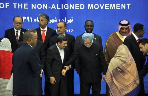 Iranian leader Mahmoud Ahmadinejad (C-L) and Indian Prime Minister Manmohan Singh (C-R) stand amid other leaders and delegates of the Non-Aligned Movement as they pose for a photo before the summit's start. The summit stumbled as soon as it opened on Thursday when the head of the UN pressed Tehran on its nuclear stand, and Egypt's new leader publicly sided with Syria's opposition