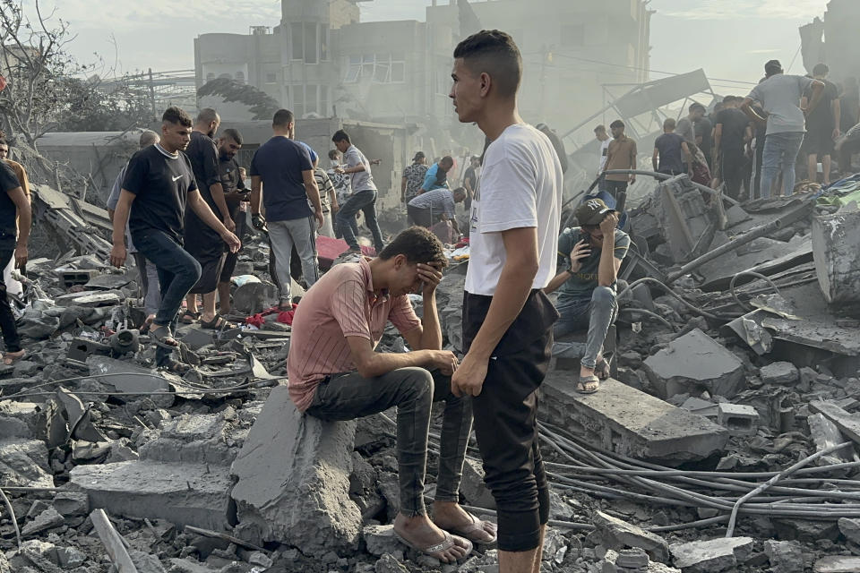 FILE - Palestinians look for survivors following Israeli airstrike in Nusseirat refugee camp, Gaza Strip, Tuesday, Oct. 31, 2023. Israel and Hamas have both been accused of breaking the rules of armed conflict. Hamas killed hundreds of civilians and abducted scores more when it attacked southern Israel on Oct. 7. Israel has bombarded Gaza and told more hundreds of thousands of Palestinians to leave their homes. The United Nations says it is collecting evidence of war crimes by all sides. But holding perpetrators to account for is often difficult. (AP Photo/Doaa AlBaz, File)