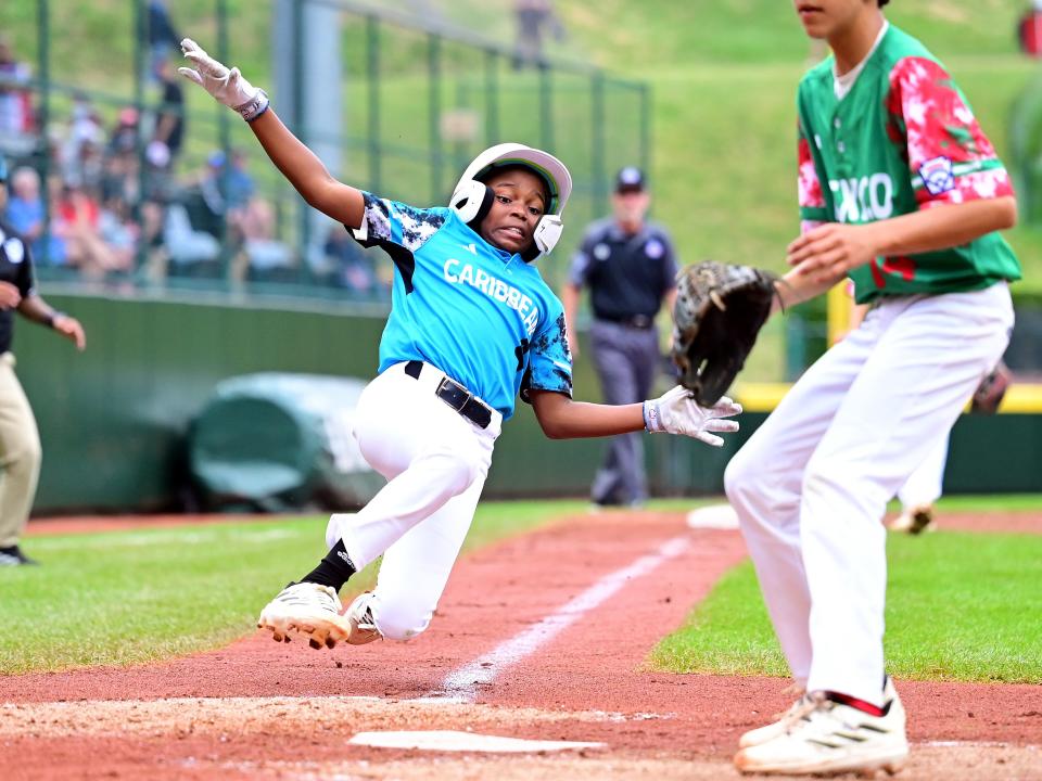 Aug. 24: Caribbean Region player Jayvery Felicia slides to score a run in the fourth inning against Mexico Region. Curacao won the game, 4-2.