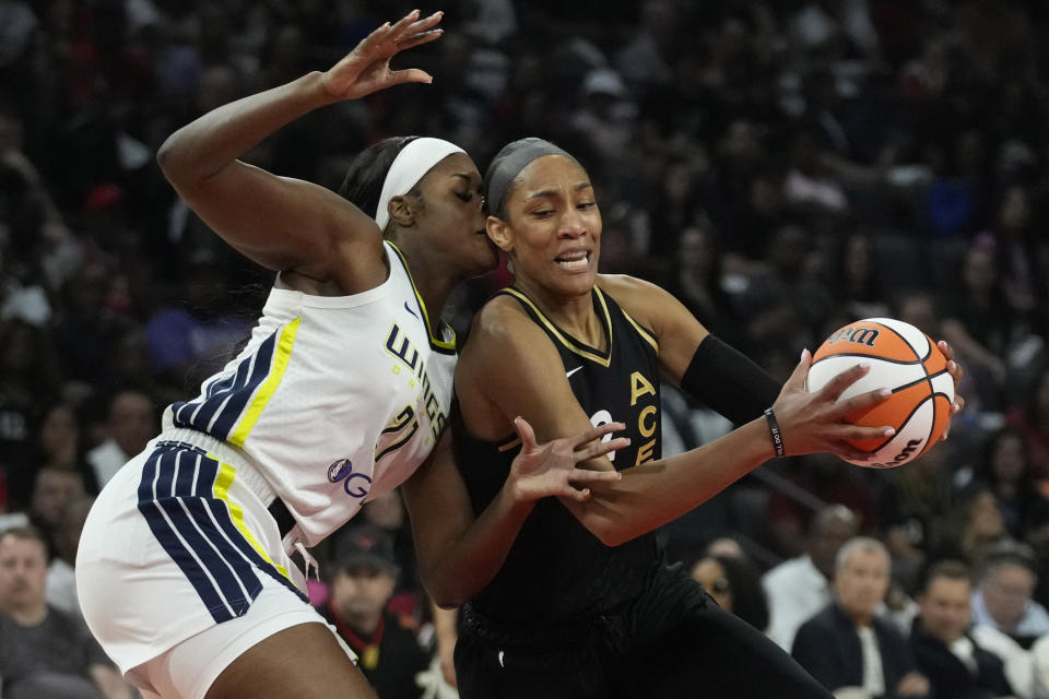 Las Vegas Aces forward A'ja Wilson (22) drives against Dallas Wings center Kalani Brown (21) during the first half in Game 2 of a WNBA basketball semifinal series Tuesday, Sept. 26, 2023, in Las Vegas. (AP Photo/John Locher)