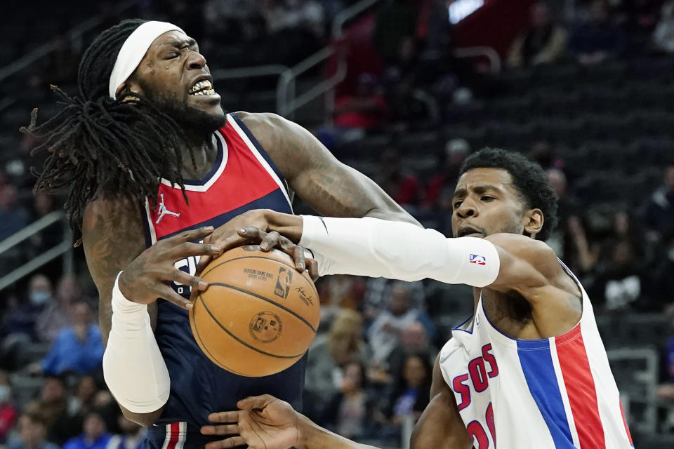 Detroit Pistons guard Josh Jackson (20) knocks the ball away from Washington Wizards center Montrezl Harrell during the first half of an NBA basketball game, Wednesday, Dec. 8, 2021, in Detroit. (AP Photo/Carlos Osorio)