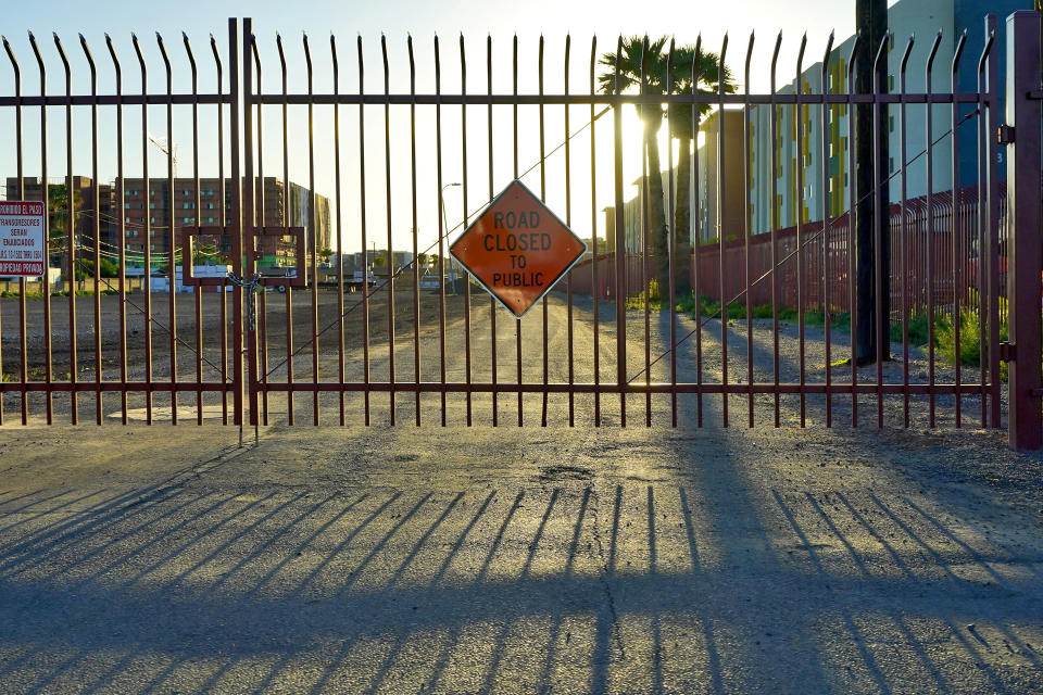 What was once a public street into the Periwinkle Mobile Home Park now is fenced off, Thursday, April 11, 2023, in Phoenix. Residents of the park are facing an eviction deadline of May 28 due to a private university's plan to redevelop the land for student housing. (AP Photo/Matt York)