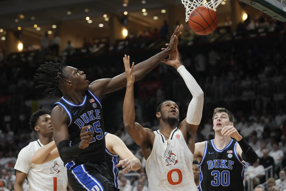 Duke forward Mark Mitchell (25) blocks a shot to the basket by Miami forward A.J. Casey (0) during the first half of an NCAA college basketball game, Monday, Feb. 6, 2023, in Coral Gables, Fla. (AP Photo/Marta Lavandier)