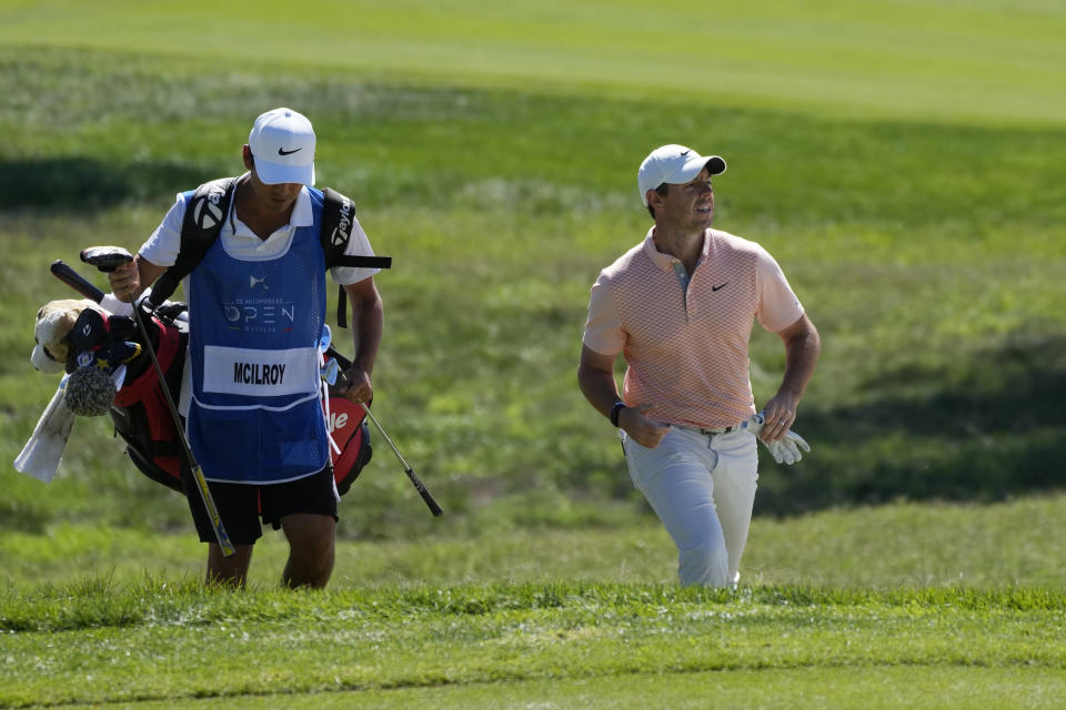 Rory McIlroy of Northern Ireland, right, walks on the course during the Italian Open golf tournament in Guidonia Montecelio, near Rome, Italy, Sunday, Sept. 18, 2022. The Italian Open took place on the Marco Simone course that will host the 2023 Ryder Cup. (AP Photo/Alessandra Tarantino)