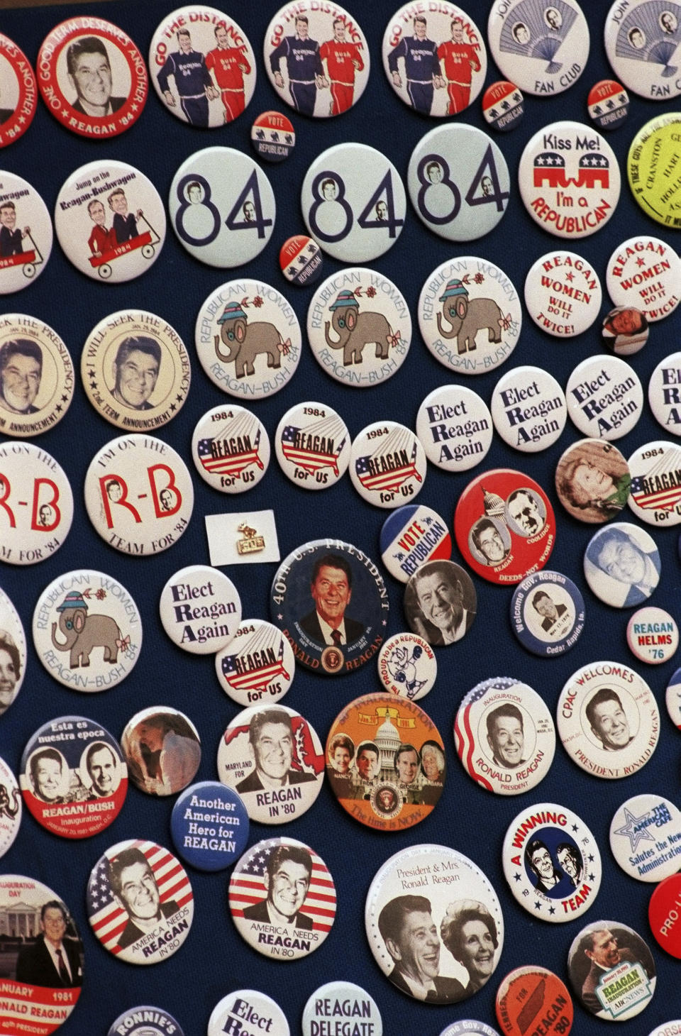 FILE - This photo shows buttons from the 1984 Reagan-Bush campaign. Reagan announced on Jan. 29, 1984. His approval rating was 52% that month. Despite concerns about his age — he was 73 and the oldest president in history at the time — Reagan handily defeated Walter Mondale, a Democrat. (AP Photo, File)