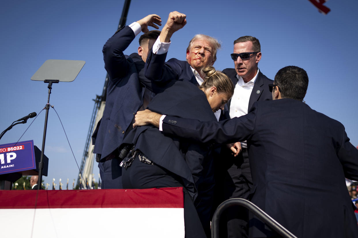 A bloodied Donald Trump is surrounded by Secret Service agents at a campaign rally in Butler, Pa, on Saturday, July 13, 2024. (Doug Mills/The New York Times)