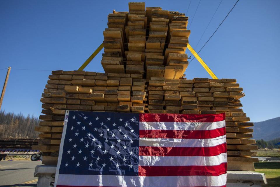 Lumber trucks display the Stars and Stripes in Greenville's Gold Diggers Day parade.