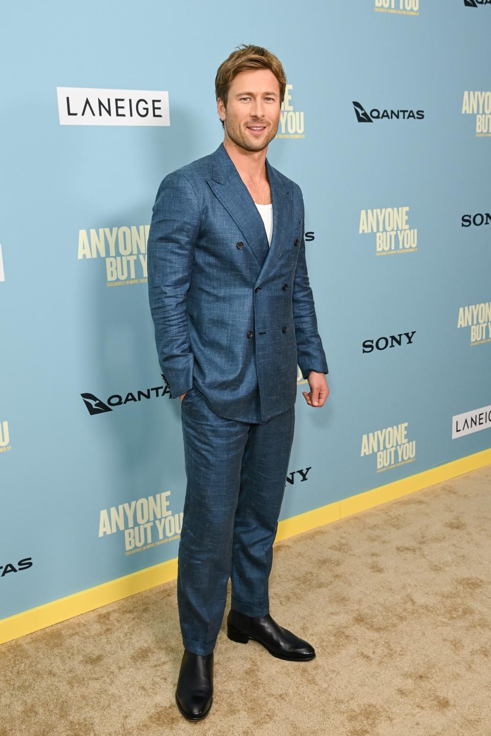 Glen Powell in a light blue suit