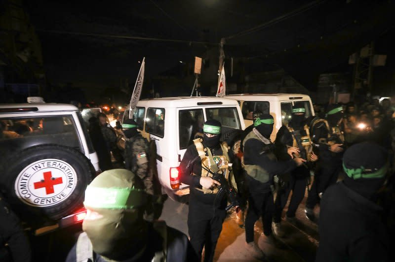 Hamas fighters escort newly released hostages before handing them over to the International Red Cross in Rafah in the southern Gaza Strip on Tuesday, November 28, 2023. Photo by UPI