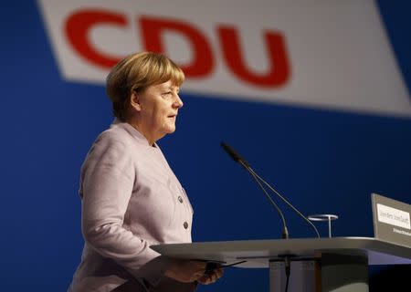 German Chancellor and leader of the conservative Christian Democratic Union party CDU Angela Merkel walks inside the Grugahalle in Essen ahead a CDU party convention in Essen, Germany, December 5, 2016. REUTERS/Wolfgang Rattay