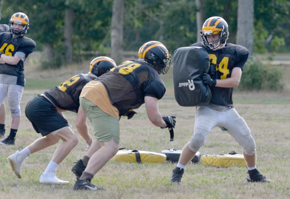 NORTH EASTHAM -- 08/29/22 -- Alex Leighton, right, holds up a blocking shield during a practice drill. 
Nauset Regional High School football is back in action. A practice was held Monday morning.