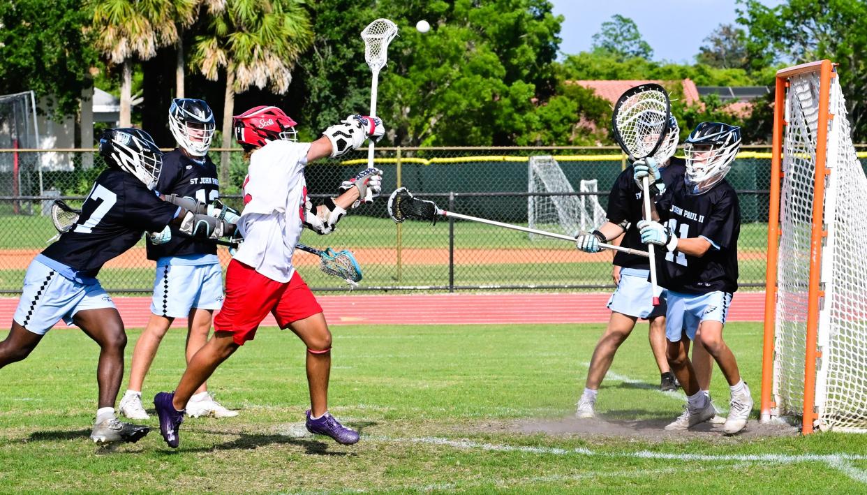 St. Andrew's Nick Testa goes in hard for the goal shot in a regional final game win against St. John Paul II on May 4, 2024.