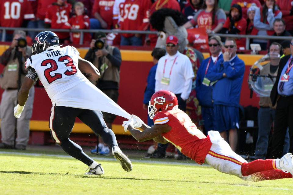 Kansas City Chiefs cornerback Bashaud Breeland (21) hangs on to the jersey of Houston Texans running back Carlos Hyde (23) during the second half of an NFL football game in Kansas City, Mo., Sunday, Oct. 13, 2019. The Houston Texans won 31-24. (AP Photo/Ed Zurga)