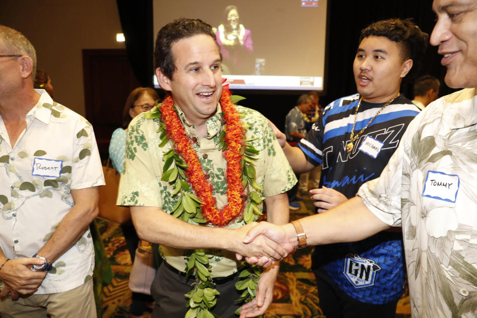 Sen. Brian Schatz, D-Hawaii, greets supporters at the Democratic Party headquarters, Tuesday, Nov. 8, 2022, in Honolulu. (AP Photo/Marco Garcia)