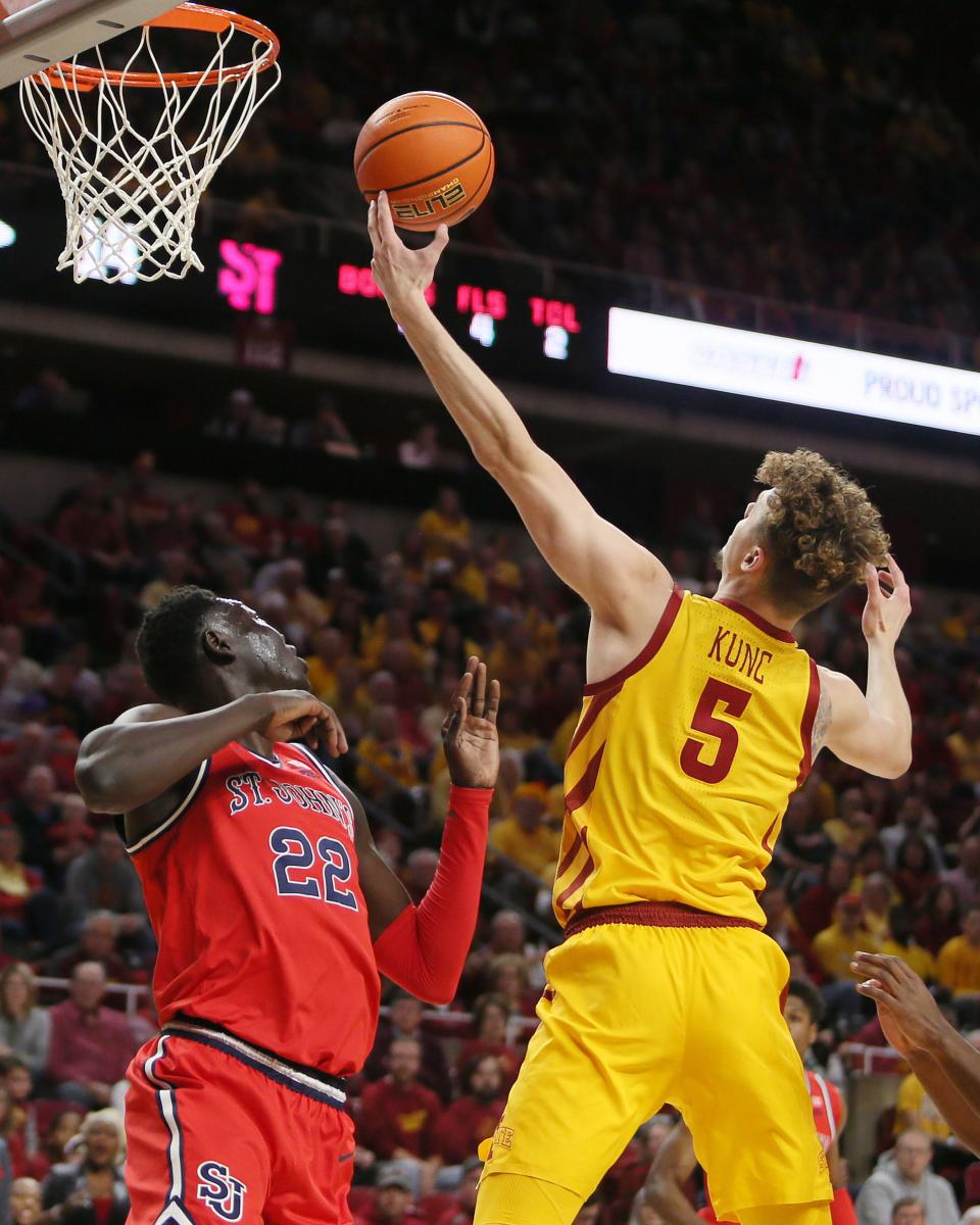 Iowa State's Jaz Kunc (5) rebounds the ball over St. John's Esahia Nyiwe (22) during the first half of Sunday's game at Hilton Coliseum.
