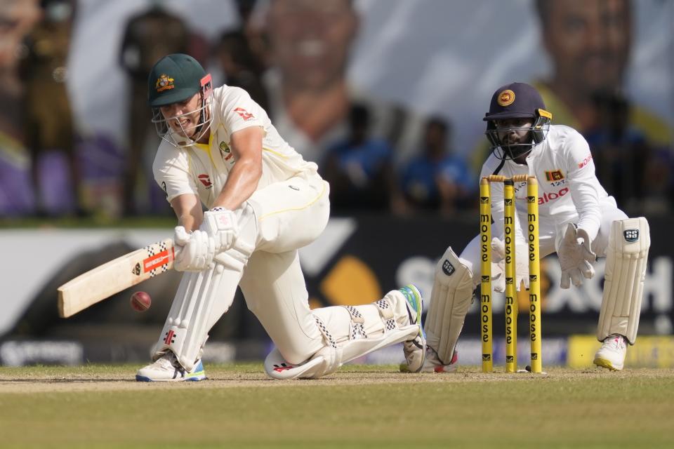 Australia's Cameron Green plays a shot Niroshan Dickwella watches during the day two of the first test cricket match between Australia and Sri Lanka in Galle, Sri Lanka, Thursday, June 30, 2022. (AP Photo/Eranga Jayawardena)