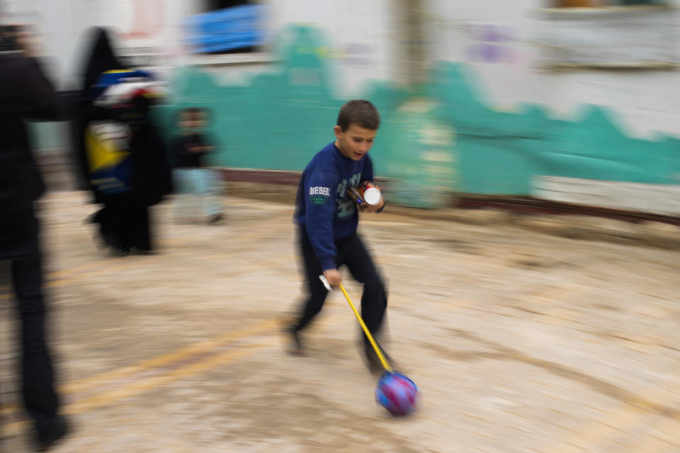 A Syrian boy plays with a donated toy in Taybe orphanage refugee camp for displaced people run by the Turkish Red Crescent in Sarmada district, on the outskirts north of Idlib, Syria, Thursday, Nov. 25, 2021. (AP Photo/Francisco Seco)