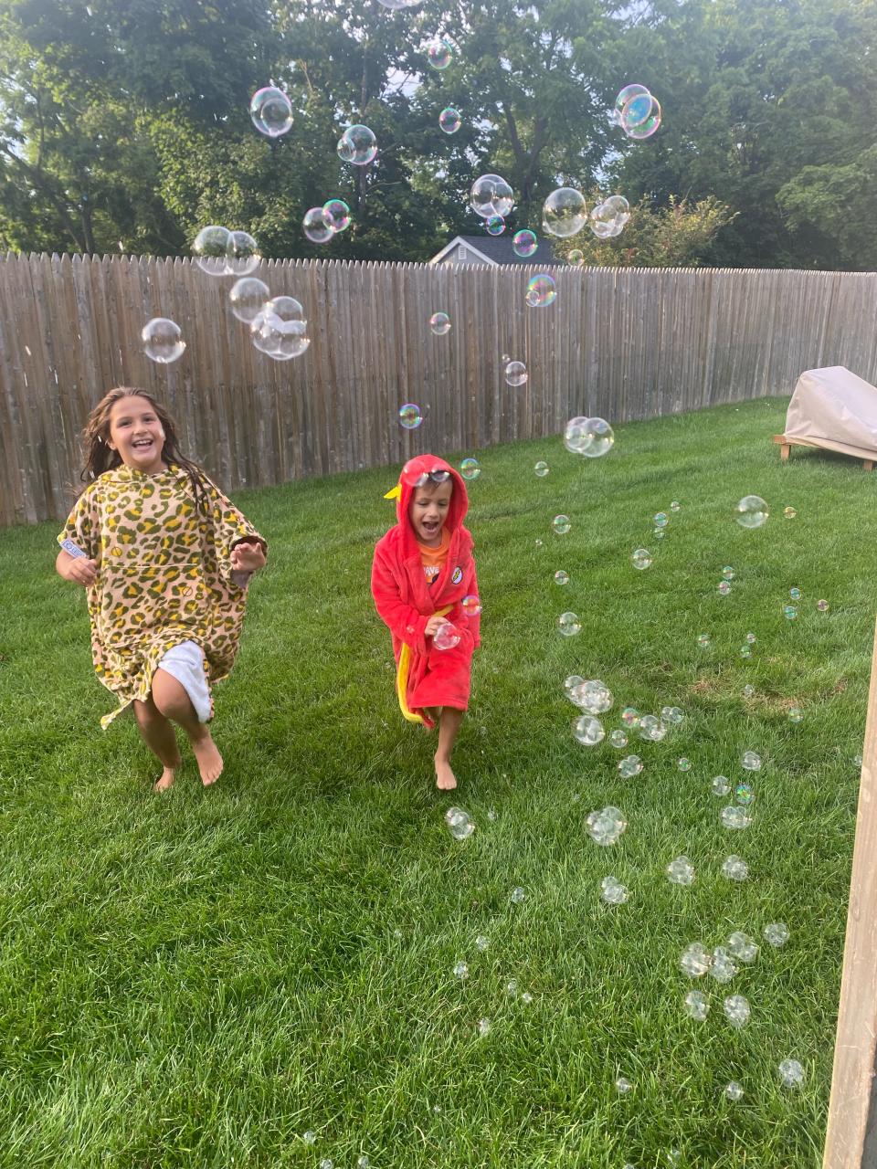 Madison, 8, and Charlie DeFraia, 4, playing in the backyard of their Long Island home.