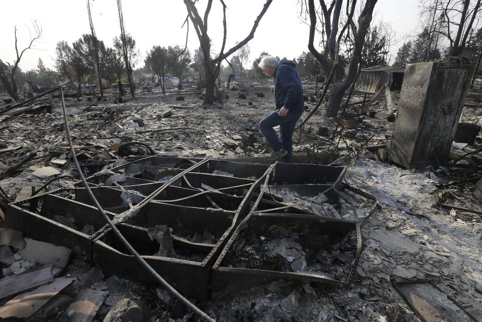 On the ground, a devastated homeowner in Santa Rosa tries to come to terms with the damage. (AP Photo/Jeff Chiu)