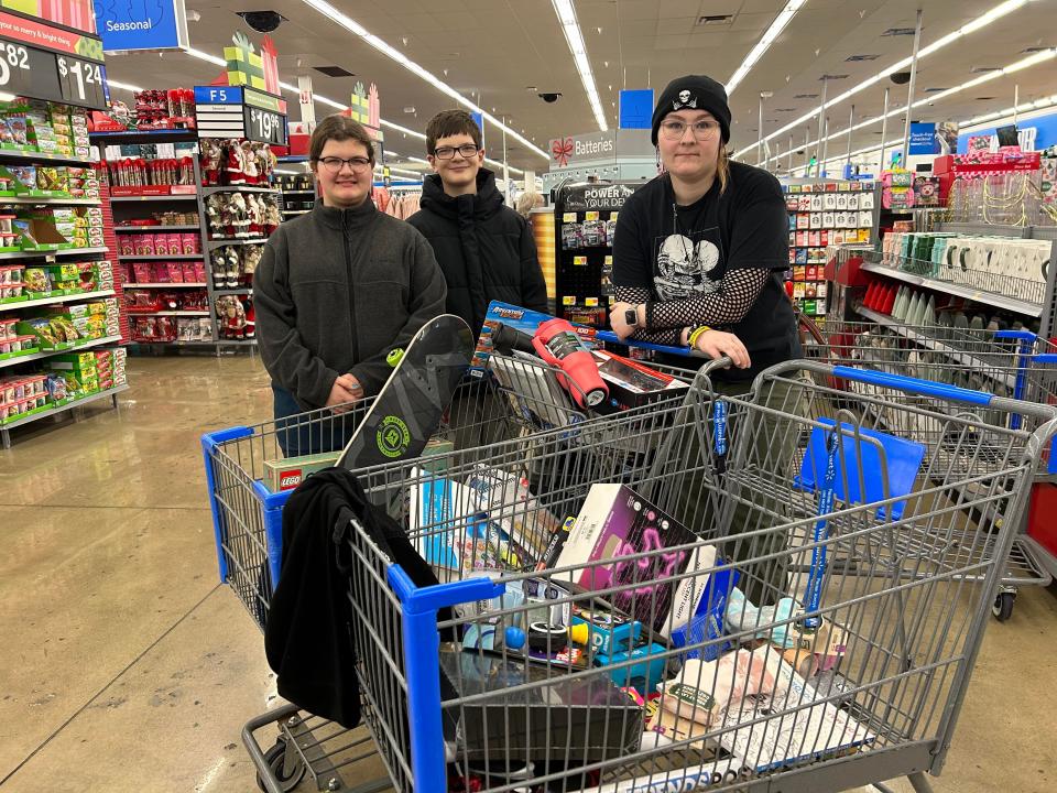 Members of the Woodville Buckeyes 4-H Club shop for the Angel Tree. Youths are Alaina Boyd (wearing hat), Cora Haslinger and Sam Haslinger.