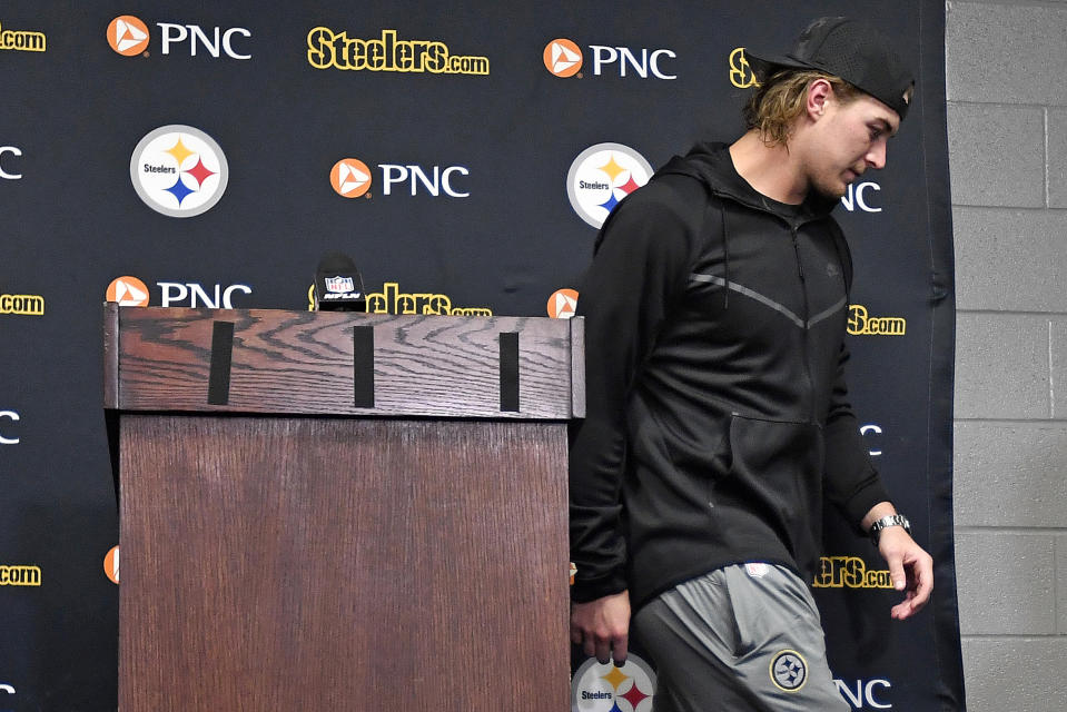 Pittsburgh Steelers quarterback Kenny Pickett, center, leaves the podium after meeting with reporters after an NFL football game against the Buffalo Bills in Pittsburgh, Sunday, Oct. 9, 2022. The Bills won 38-3. (AP Photo/Adrian Kraus)