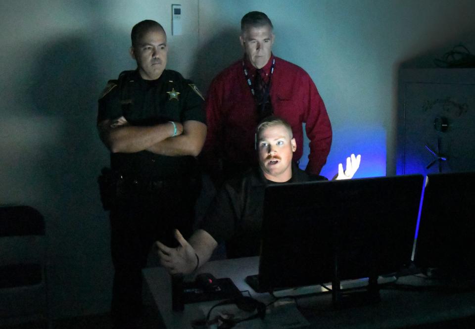 Corporal Jeremy Flake, pictured at the controls in a March 2019 photo, describes the workings of the high-tech MILO Range 300 Theater set up at a Brevard County Sheriff's Office facility in Sharpes. The Range is used as part of a program to help train school guardians.