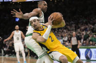 Indiana Pacers guard Andrew Nembhard (2) drives against Boston Celtics center Al Horford (42) during the fourth quarter of Game 1 of the NBA Eastern Conference basketball finals, Tuesday, May 21, 2024, in Boston. (AP Photo/Charles Krupa)