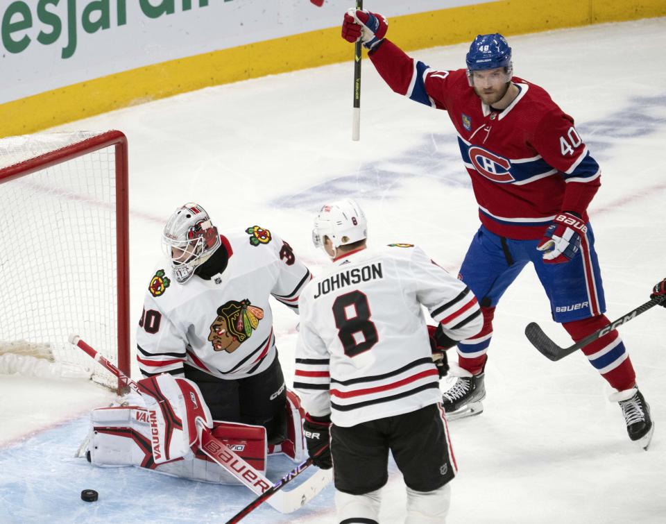 Montreal Canadiens' Joel Armia (40) celebrates a goal against Chicago Blackhawks goaltender Jaxson Stauber (30) as Chicago Blackhawks Jack Johnson (8) looks on during the first period an NHL hockey game Tuesday, Feb. 14, 2023 in Montreal. (Ryan Remiorz/The Canadian Press via AP)