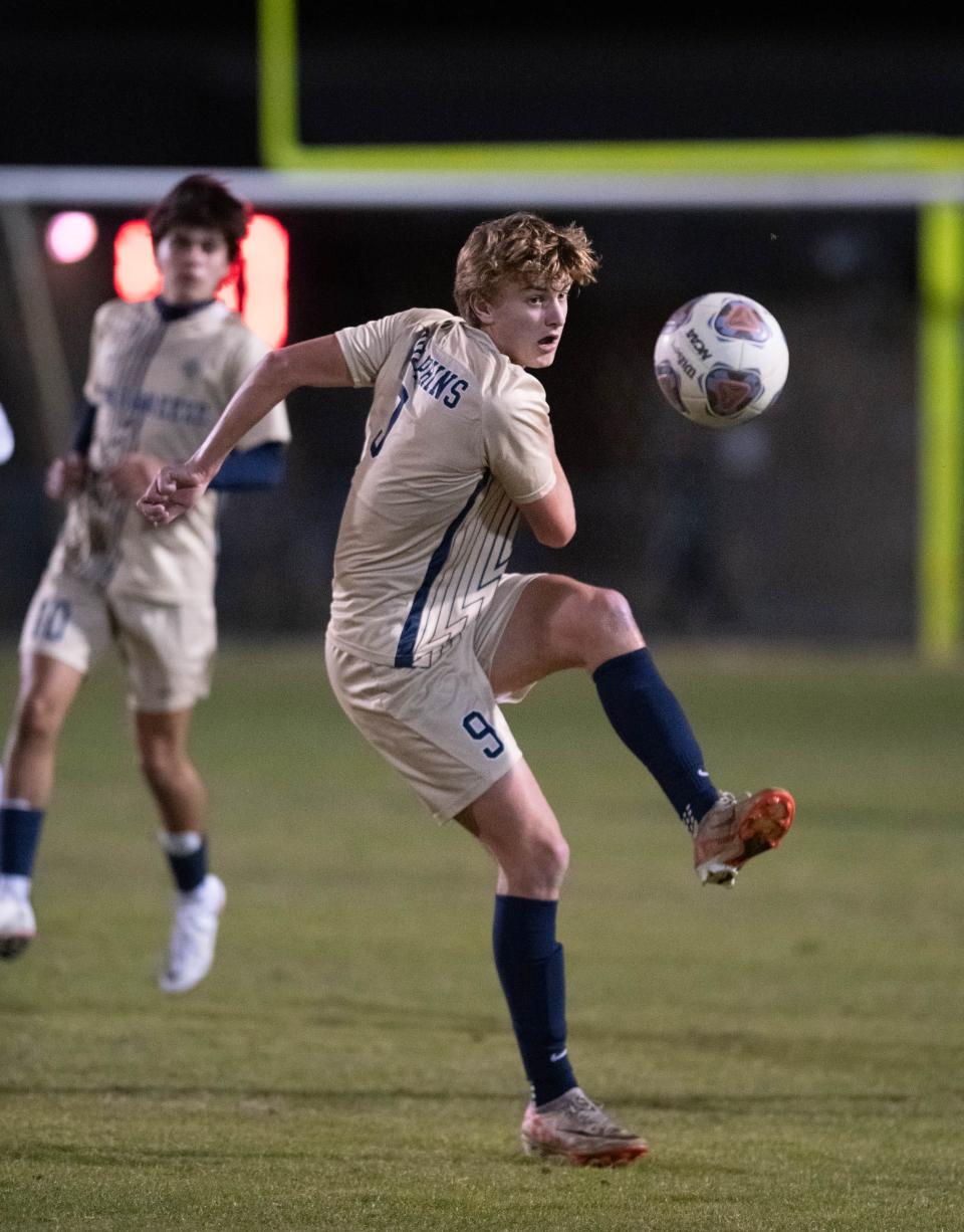 Lucas Isakson (9) passes the ball during the Booker T. Washington vs Gulf Breeze boys soccer game at Gulf Breeze High School on Thursday, Jan. 11, 2024.