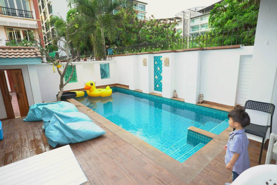 A boy is pictured by a villa pool in Thailand.