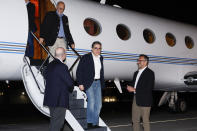 U.S. Special Presidential Envoy for Hostage Affairs Roger Carstens, right, greets freed Americans Siamak Namazi, Morad Tahbaz and Emad Shargi, as well as two returnees whose names have not yet been released by the U.S. government, who were released in a prisoner swap deal between U.S and Iran, as they arrive at Davison Army Airfield, Tuesday, Sept. 19, 2023 at Fort Belvoir, Va. (Jonathan Ernst/Pool via AP)