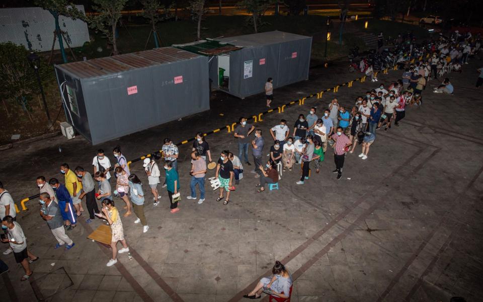 Residents queueing to receive a nucleic acid test for the Covid-19 in Nanjing - AFP
