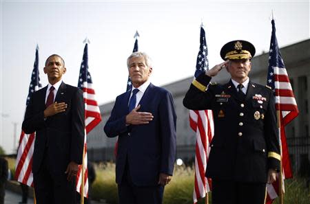 U.S. President Barack Obama (L-R), Secretary of Defense Chuck Hagel and Chairman of the Joint Chiefs of Staff Martin Dempsey participate in an event on the 12th anniversary of the 9/11 attacks at the Pentagon near Washington, September 11, 2013. REUTERS/Jason Reed