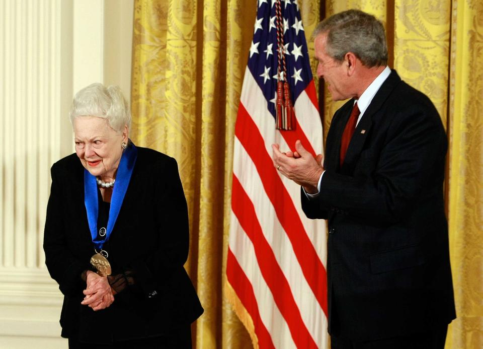 George W Bush, then US president, congratulates actress Olivia de Havilland after presenting her with the 2008 National Medals of Arts award during an event in the East Room at the White House in November 2008.