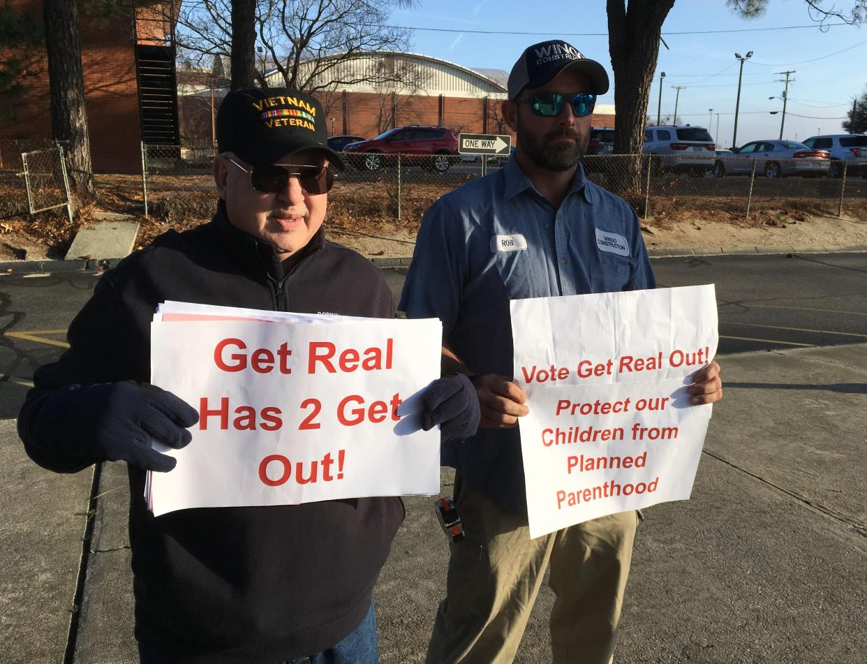 Wayne Dorman, left, and Rob Wingo hold signs opposing the Get Real sex education curriculum outside Cumberland County school board committee meetings in February 2018. The program started in 2009 and was proven to delay sexual activity in teens but the county shelved it not long after protests gained traction. FAYETTEVILLE OBSERVER FILE PHOTO