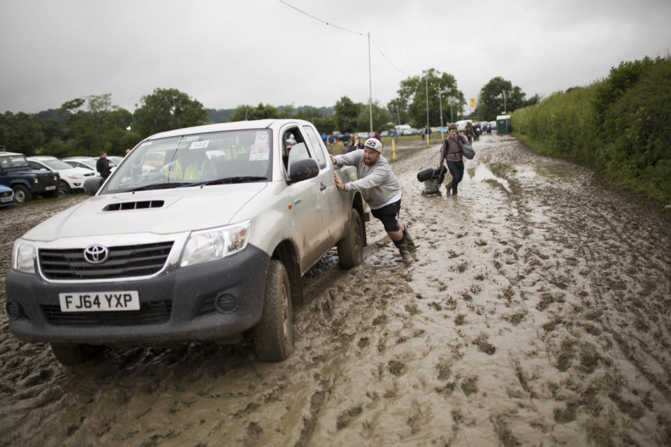 Push! A truck needs some assistance making its way on site. (SWNS)