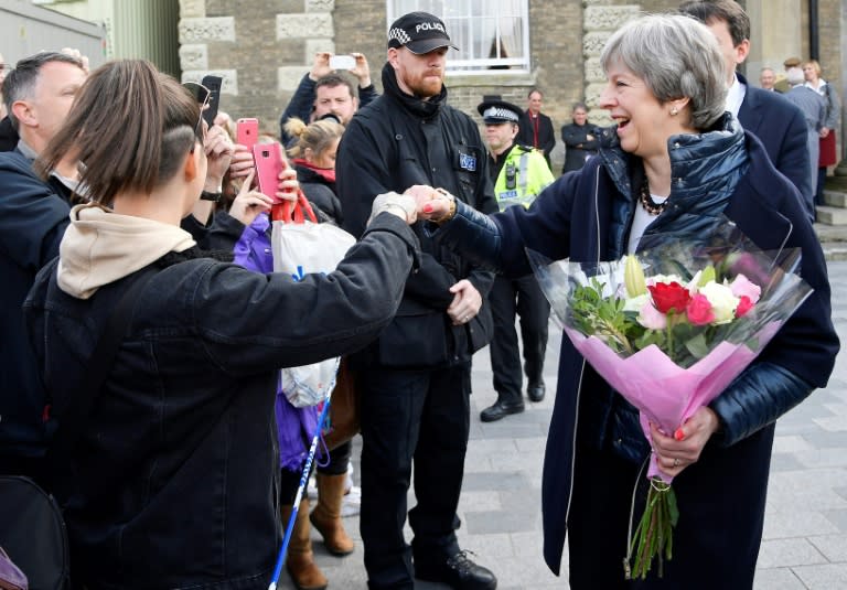 Prime Minister Theresa May, nicknamed "Maybot" for her awkward interactions with the public, "fist-bumped" a well-wisher and had people shout her name in praise on a visit to the site of the poisoning of a former Russian double agent