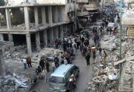 Syrians inspect the damage following an air strike on the village of Maaret al-Numan, in Idlib province -- which is mostly controlled by a powerful rebel alliance known as the Army of Conquest