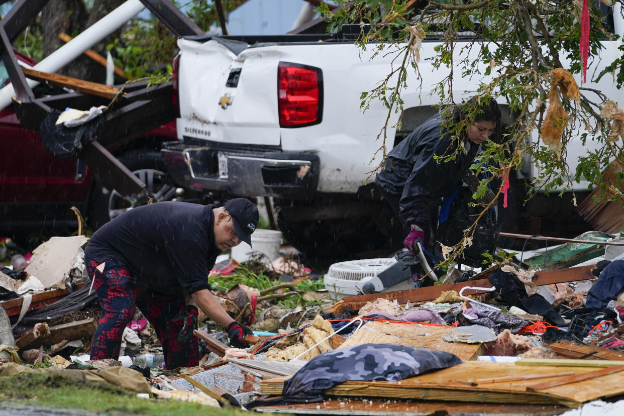 People salvage items from a destroyed home after a tornado hit Texas, Saturday, May 13, 2023, in the unincorporated community of Laguna Heights, Texas near South Padre Island. Authorities say one person was killed when a tornado struck the southernmost tip of Texas on the Gulf coast. (AP Photo/Julio Cortez)