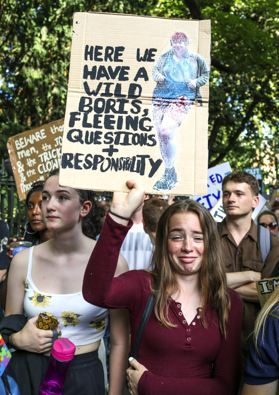 Young people take to the streets to oppose the election of the new British Prime Minister Boris Johnson in London, Wednesday, July 24, 2019. Boris Johnson has replaced Theresa May as Prime Minister, following her resignation last month after Parliament repeatedly rejected the Brexit withdrawal agreement she struck with the European Union. (AP Photo/Vudi Xhymshiti)