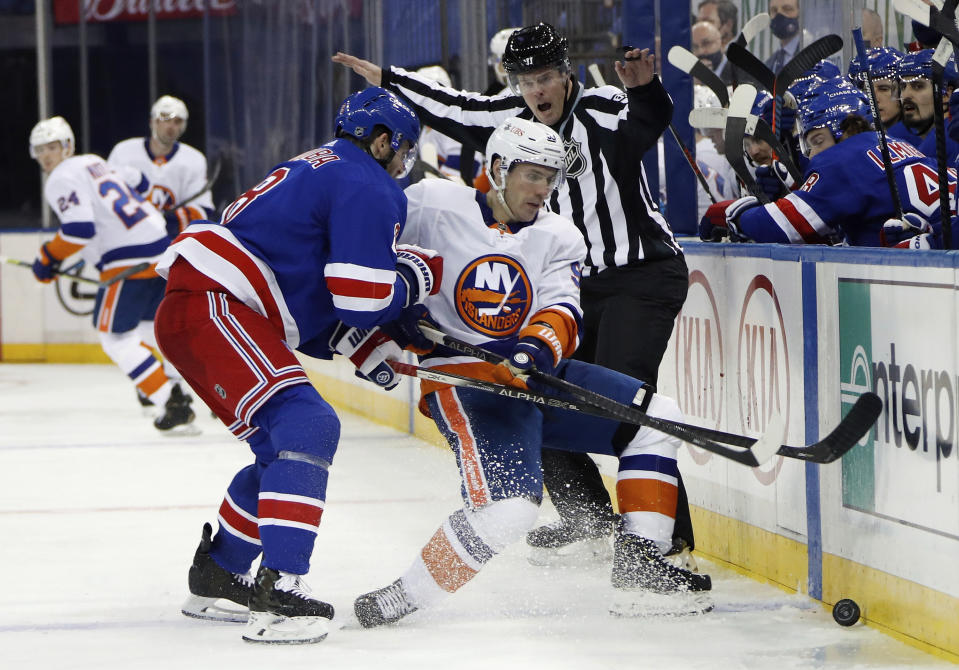 New York Rangers' Jacob Trouba (8) rides New York Islanders' Casey Cizikas in to the boards during the third period of an NHL hockey game Thursday, Jan. 14, 2021, in New York. (Bruce Bennett/Pool Photo via AP)