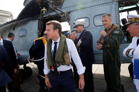 France's President Emmanuel Macron waits on the tarmac of Pointe-a-Pitre airport, Guadeloupe island, before boarding an helicopter en route to French Caribbean islands of St. Martin and St. Barthelemy, September 12, 2017. REUTERS/Christophe Ena/Pool