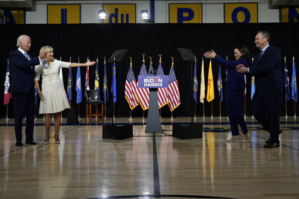 FILE - Sen. Kamala Harris, D-Calif., and her husband, Douglas Emhoff, right, clap for Democratic presidential candidate former Vice President Joe Biden and his wife, Jill Biden, after a campaign event at Alexis Dupont High School in Wilmington, Del., Wednesday, Aug. 12, 2020. (AP Photo/Carolyn Kaster, File)